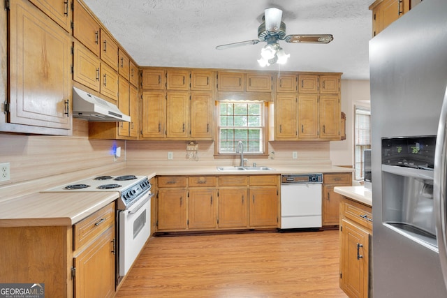 95 Stephens Dr, Covington, GA 30016 - kitchen featuring white appliances, under cabinet range hood, a sink, light countertops, and a textured ceiling