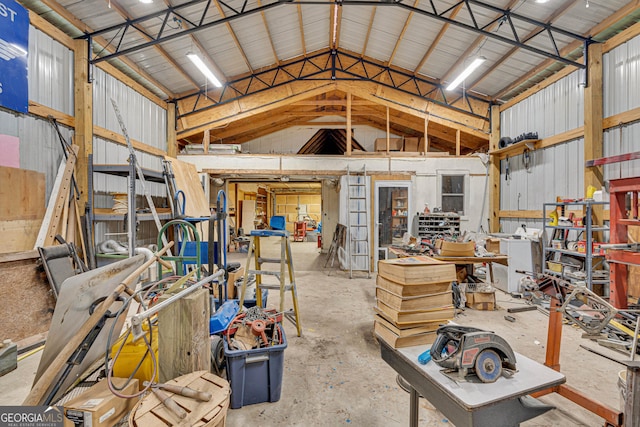 95 Stephens Dr, Covington, GA 30016 - misc room featuring metal wall, a workshop area, concrete floors, and high vaulted ceiling
