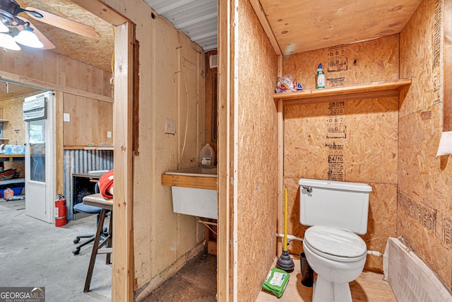 95 Stephens Dr, Covington, GA 30016 - bathroom featuring toilet, ceiling fan, and radiator heating unit