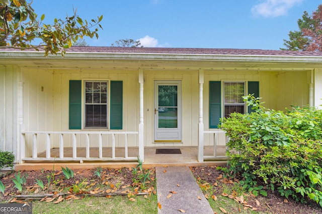 95 Stephens Dr, Covington, GA 30016 - property entrance featuring a porch, a shingled roof, and board and batten siding