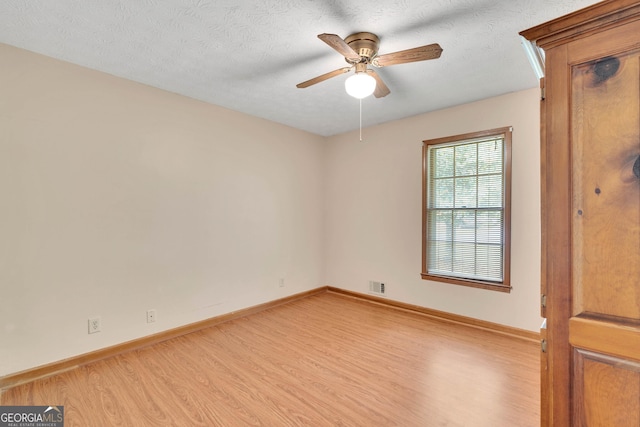 95 Stephens Dr, Covington, GA 30016 - unfurnished room featuring light wood finished floors, baseboards, a ceiling fan, and a textured ceiling