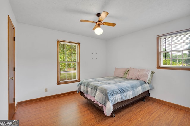 95 Stephens Dr, Covington, GA 30016 - bedroom with light wood-type flooring, baseboards, and a ceiling fan