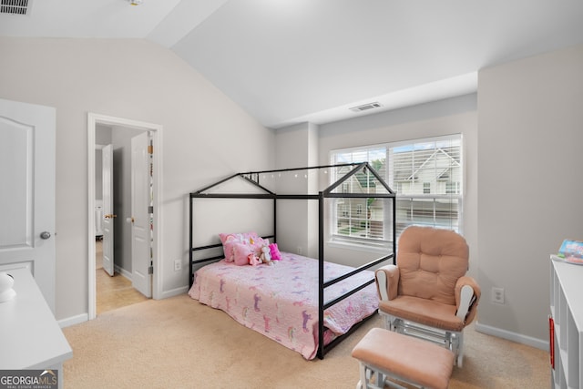 bedroom featuring light colored carpet, vaulted ceiling, and baseboards