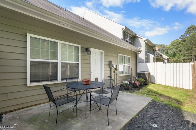 view of patio / terrace featuring cooling unit, fence, and outdoor dining area