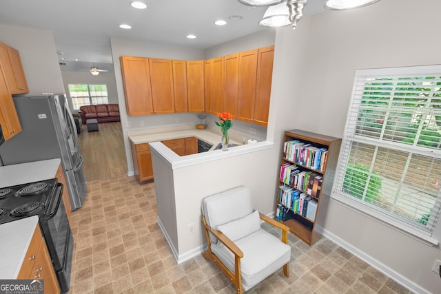 kitchen with a ceiling fan, light countertops, black range with electric cooktop, baseboards, and recessed lighting