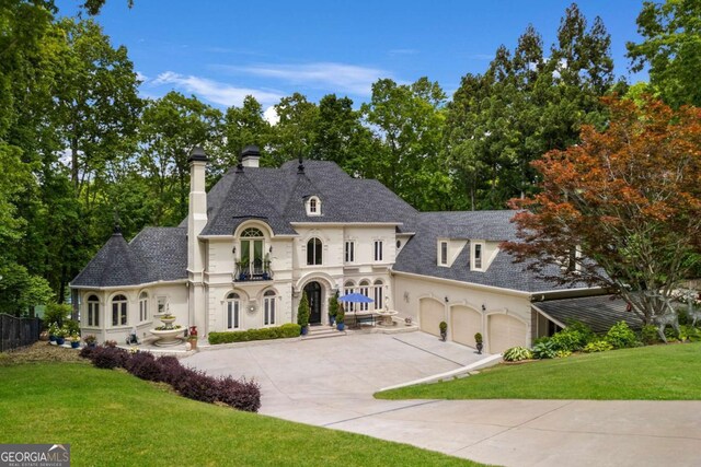 3182 Deepwater Dr, Gainesville, GA 30506 - french country inspired facade with concrete driveway, a front yard, a chimney, a balcony, and stucco siding
