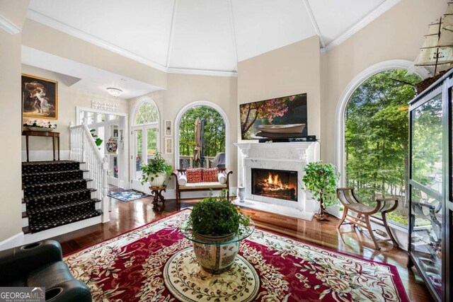 3182 Deepwater Dr, Gainesville, GA 30506 - living area with wood finished floors, a high end fireplace, high vaulted ceiling, and ornamental molding