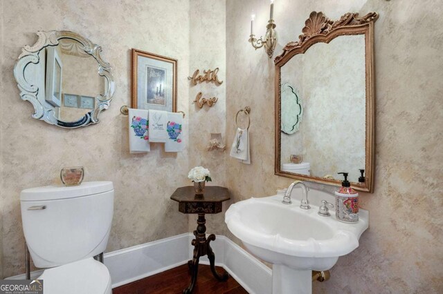 3182 Deepwater Dr, Gainesville, GA 30506 - half bath with toilet, wood finished floors, a sink, and baseboards