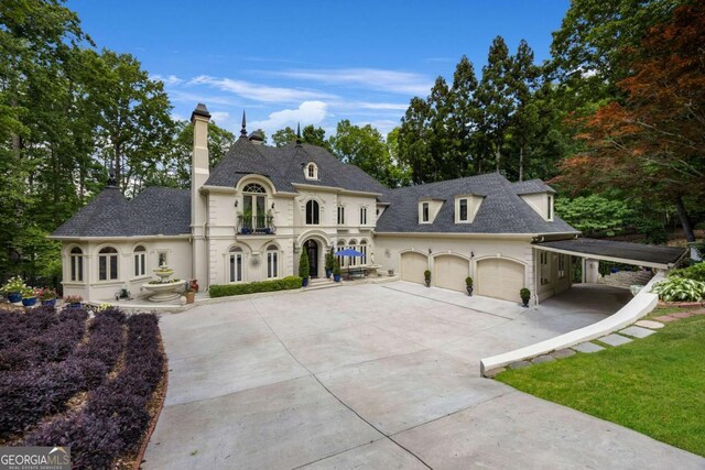 3182 Deepwater Dr, Gainesville, GA 30506 - french country style house with driveway, a chimney, a garage, a carport, and a shingled roof