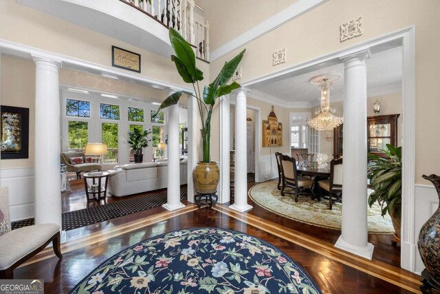 3182 Deepwater Dr, Gainesville, GA 30506 - living area with decorative columns, wood finished floors, crown molding, a wainscoted wall, and a decorative wall