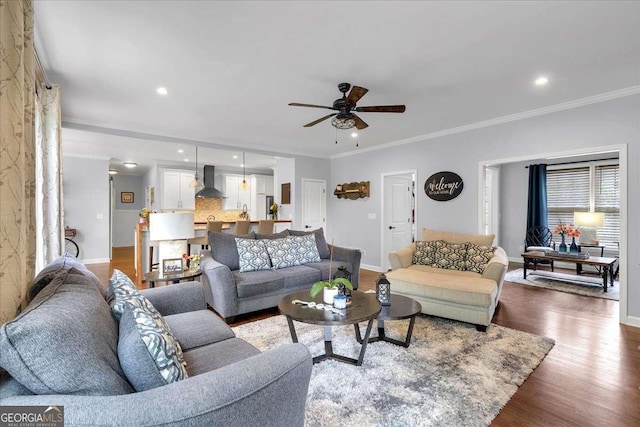 living room with baseboards, a ceiling fan, ornamental molding, dark wood-style flooring, and recessed lighting