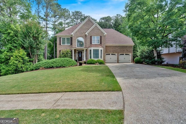view of front facade featuring an attached garage, concrete driveway, a front lawn, and brick siding