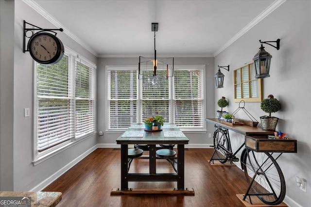 dining area with baseboards, wood finished floors, and crown molding