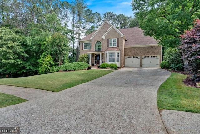 view of front of house with concrete driveway, an attached garage, a front lawn, and brick siding