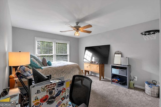 carpeted bedroom featuring baseboards and ceiling fan