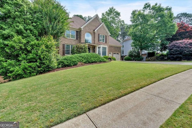 view of front of house featuring a front yard and brick siding