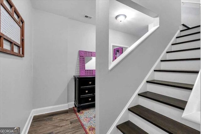 stairway featuring wood finished floors and baseboards