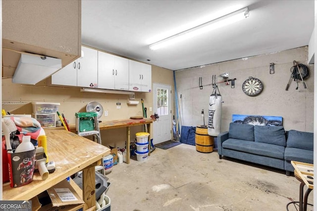 basement with a workshop area and water heater