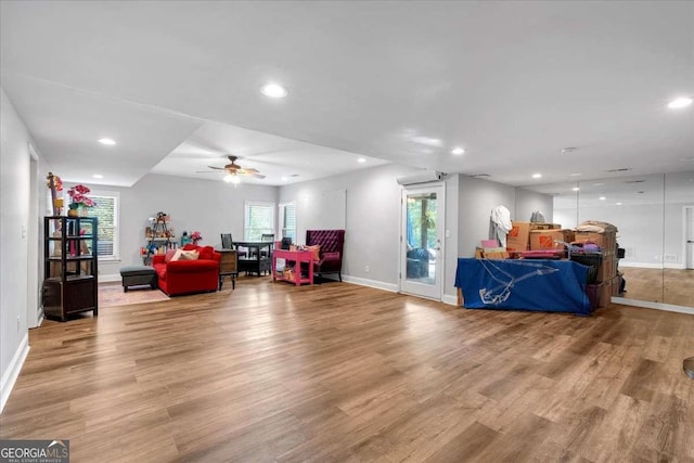 living room with ceiling fan, baseboards, light wood-style floors, and recessed lighting