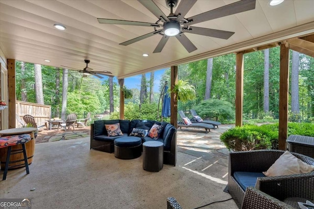 view of patio featuring ceiling fan, outdoor lounge area, and fence