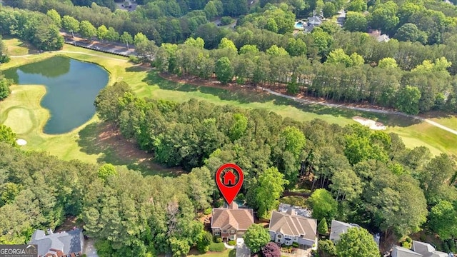 view of property location with a nearby body of water, a golf club, and nearby suburban area