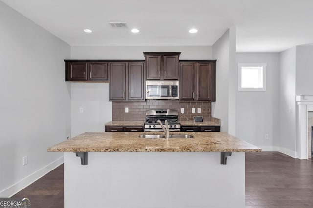 2342 Terrace View Cir SW, Atlanta, GA 30315 - kitchen with stainless steel appliances, baseboards, dark brown cabinetry, decorative backsplash, and dark wood-style flooring