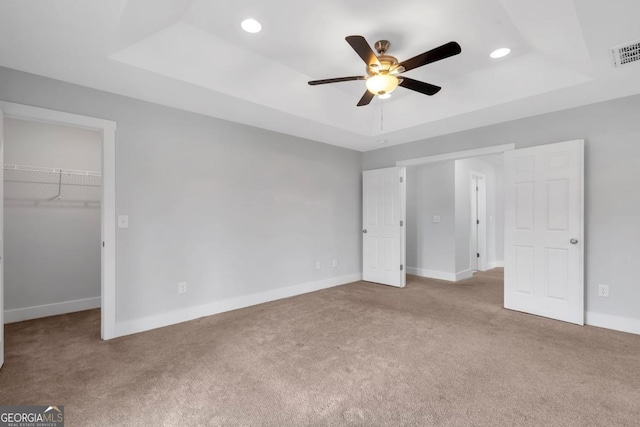 2342 Terrace View Cir SW, Atlanta, GA 30315 - unfurnished bedroom featuring a raised ceiling, carpet flooring, a walk in closet, recessed lighting, and baseboards