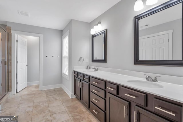 2342 Terrace View Cir SW, Atlanta, GA 30315 - bathroom with double vanity, an enclosed shower, and baseboards