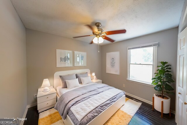 180 Old Airport Rd, Carrollton, GA 30116 - bedroom with baseboards, wood finished floors, and a ceiling fan