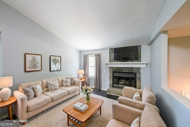 180 Old Airport Rd, Carrollton, GA 30116 - living area with a stone fireplace, vaulted ceiling, and baseboards