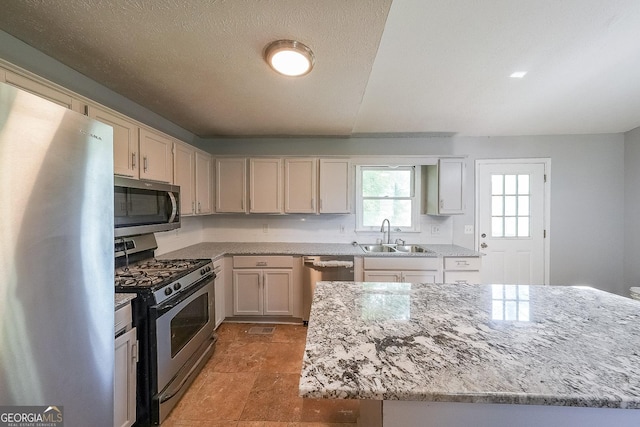 180 Old Airport Rd, Carrollton, GA 30116 - kitchen featuring stainless steel appliances, a sink, and light stone counters