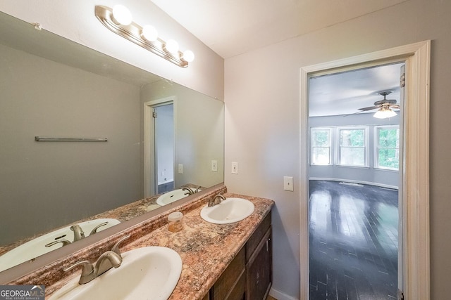180 Old Airport Rd, Carrollton, GA 30116 - bathroom with double vanity, a ceiling fan, wood finished floors, and baseboards