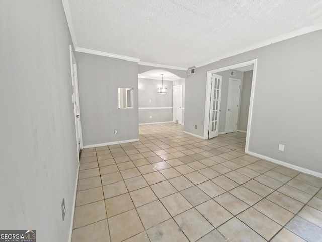 1212 Utoy Springs Rd Unit 46, Atlanta, GA 30331 - empty room with arched walkways, a textured ceiling, ornamental molding, and light tile patterned floors