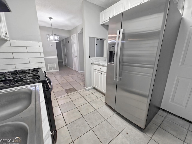 1212 Utoy Springs Rd Unit 46, Atlanta, GA 30331 - kitchen featuring stainless steel fridge with ice dispenser, range with gas stovetop, white cabinetry, tasteful backsplash, and light tile patterned floors