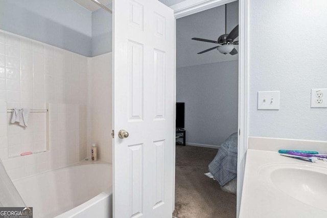 bathroom with ceiling fan, washtub / shower combination, and vanity