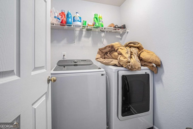 clothes washing area with washing machine and clothes dryer