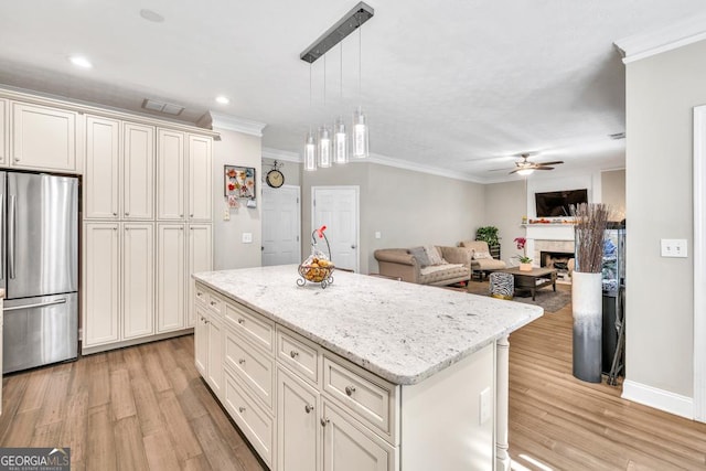 1500 Highland Farm Dr, Suwanee, GA 30024 - kitchen with freestanding refrigerator, crown molding, ceiling fan, light wood finished floors, and a kitchen island