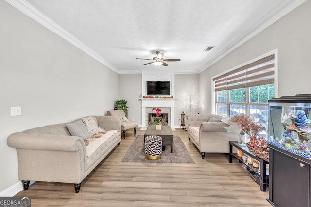 1500 Highland Farm Dr, Suwanee, GA 30024 - living room featuring a ceiling fan, ornamental molding, light wood-type flooring, a fireplace, and baseboards