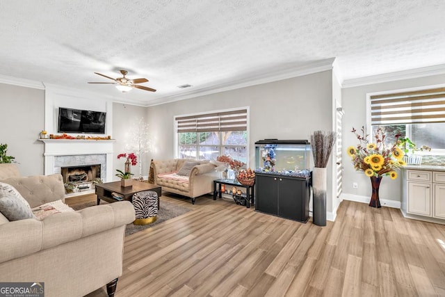 1500 Highland Farm Dr, Suwanee, GA 30024 - living room featuring light wood-type flooring, ceiling fan, a high end fireplace, a textured ceiling, and ornamental molding