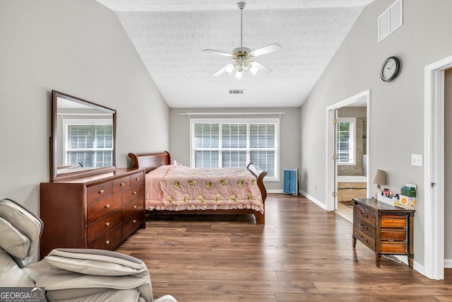 1500 Highland Farm Dr, Suwanee, GA 30024 - bedroom with vaulted ceiling, a textured ceiling, dark wood finished floors, ensuite bathroom, and baseboards