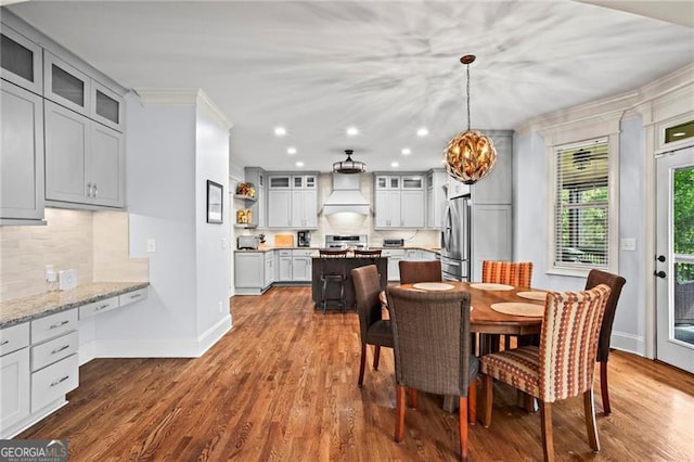 7493 Elderberry Dr, Douglasville, GA 30135 - dining space featuring a chandelier, ornamental molding, baseboards, dark wood-style flooring, and recessed lighting