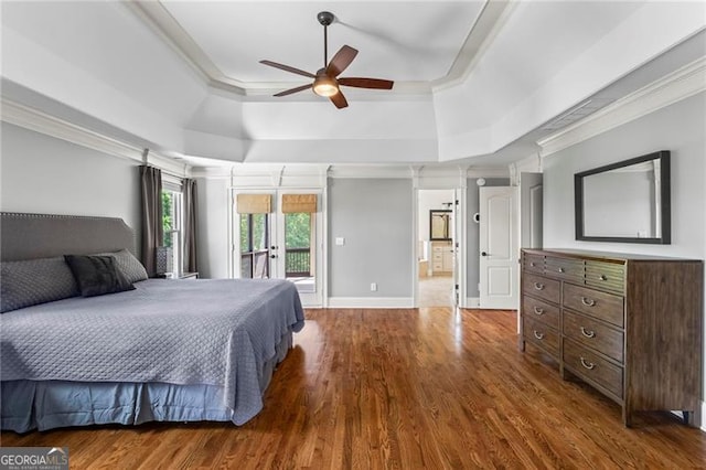 7493 Elderberry Dr, Douglasville, GA 30135 - bedroom featuring a tray ceiling, crown molding, access to exterior, dark wood finished floors, and a ceiling fan