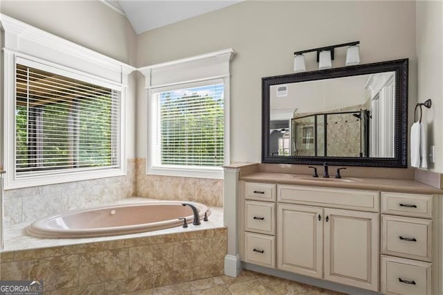 7493 Elderberry Dr, Douglasville, GA 30135 - bathroom featuring a bath, vanity, a stall shower, and vaulted ceiling