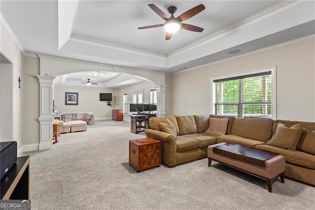 7493 Elderberry Dr, Douglasville, GA 30135 - living room featuring ornate columns, a ceiling fan, a tray ceiling, arched walkways, and crown molding