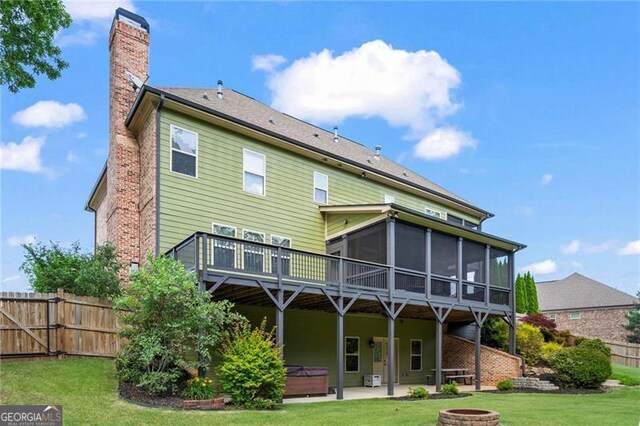 7493 Elderberry Dr, Douglasville, GA 30135 - rear view of house featuring a hot tub, a sunroom, a chimney, a patio, and a deck
