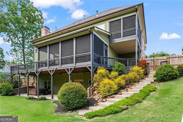 7493 Elderberry Dr, Douglasville, GA 30135 - back of property with a hot tub, a sunroom, stairs, a chimney, and a patio area