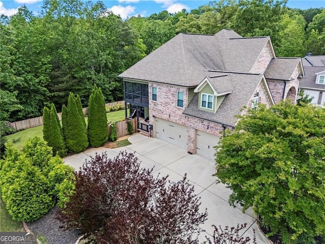 7493 Elderberry Dr, Douglasville, GA 30135 - view of side of home with fence, driveway, an attached garage, and roof with shingles