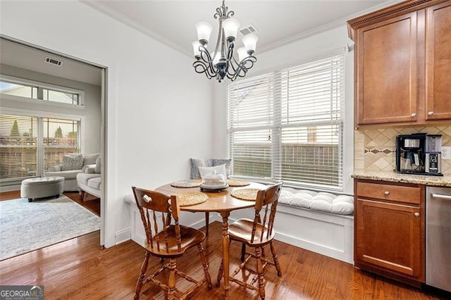 1399 Kilchis Falls Way, Braselton, GA 30517 - dining area with crown molding, dark wood-style floors, breakfast area, a chandelier, and baseboards