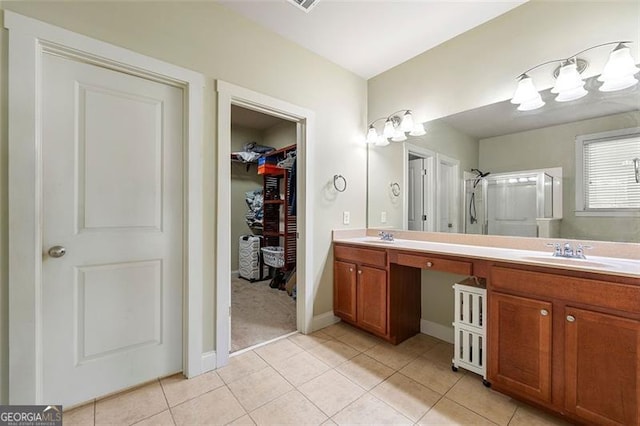 1399 Kilchis Falls Way, Braselton, GA 30517 - bathroom with double vanity, a spacious closet, tile patterned floors, a shower, and baseboards