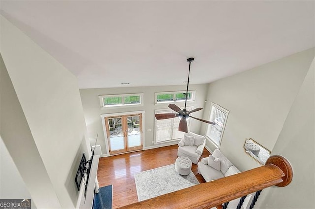 1399 Kilchis Falls Way, Braselton, GA 30517 - living room featuring french doors, wood finished floors, a ceiling fan, and baseboards